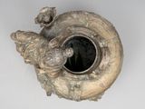 an image of a silver vase with a bird on it