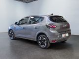 the rear view of a silver car in a showroom