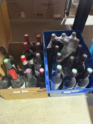many bottles of wine in a blue box on the floor