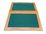 two green mats on top of each other on a white surface