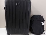 a piece of luggage sitting next to a backpack on the floor