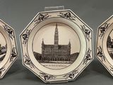 two plates with a picture of a building and a clock tower on them