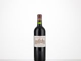 a bottle of red wine sitting on top of a table