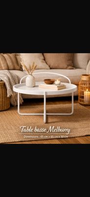 a white coffee table sitting on top of a rug in a living room