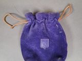 an image of a small purple bag with a tag on it