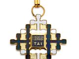a gold and enamel cross pendant with a blue and white enamel cross