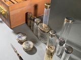 a suitcase that has a lot of bottles and spoons in it