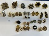 many different types of brooches on a white surface
