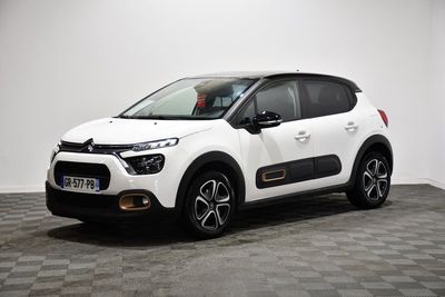 a white citrole parked in a room with a checkered floor