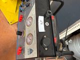 a machine that is sitting on the floor next to a yellow machine