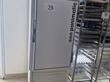an image of a refrigerator in a store with a cart in front of it