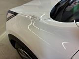 a close up of a white car with a sticker on it