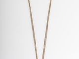 a gold necklace with a cross pendant on a chain