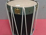 a drum that is sitting on a pink surface