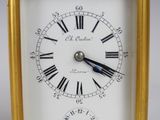 a gold clock with roman numerals on the face