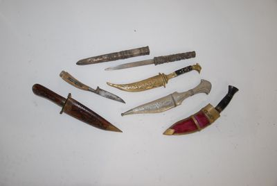 five different types of knives on a white surface