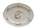 a plate with a bird design on it on a white background