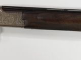 a gun hanging on the wall next to a pair of scissors