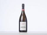 a bottle of wine sitting on top of a white table