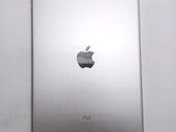 an apple ipad sitting on top of a white table next to a white wall