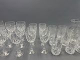 a lot of wine glasses and a pitcher on the table
