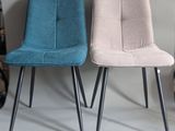 three different colored chairs sitting next to each other on a white surface