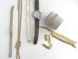 un assortiment de bijoux comprenant une montre, des bracelets et un bracelet
