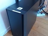 a black computer case sitting on the floor in front of a wall