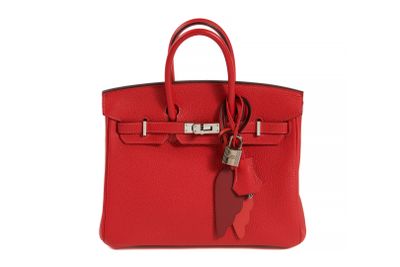 a red leather handbag with a tag on it