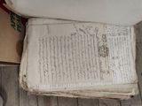 an old book sitting on the floor next to a toilet