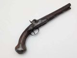 an old gun on a white surface with a white background