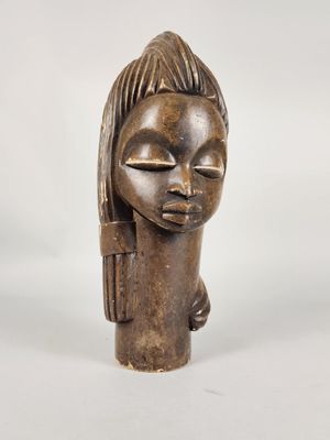 an image of a wooden sculpture of a woman with her eyes closed