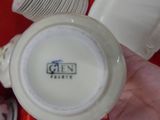 a person holding a cup and a plate with a picture on it