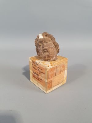a statue of a man sitting on top of a wooden box
