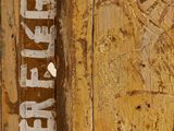 an image of a close up of a wooden door with graffiti on it