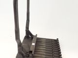 a metal grater with a handle on a white surface