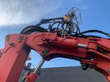 an image of a red excavator with a crane attached to it