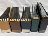 four books are lined up in a row on a white surface