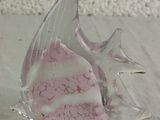 a glass fish that is sitting on a table