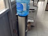 a water dispenser in the corner of a building