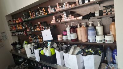 many bottles of hair products on the shelves in the store