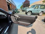 a car that is parked in a parking lot with its door open