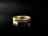 a gold ring with a purple stone in the middle