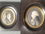 two framed portraits of two men in suits and ties, one of which is wearing a suit and the other of which is wearing a tie