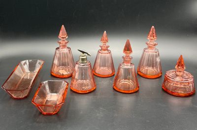 seven pieces of orange glass on a table