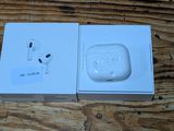 an apple airpods in a box on a wooden table