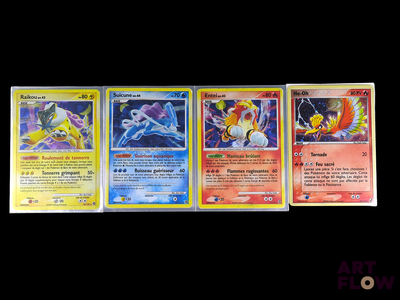 four pokemon cards are lined up in a row on a black background