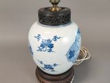 a blue and white vase on a wooden stand