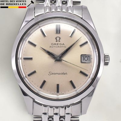 a silver watch with a brown face on a white surface