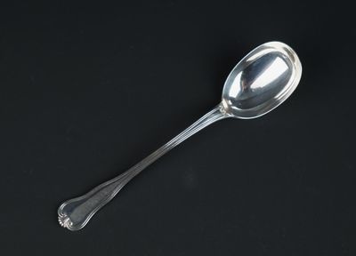 a spoon that is sitting on a black surface